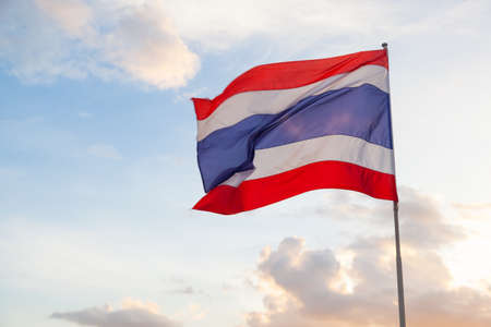 Thailand flag is blowing in the wind blows. During the evening sky