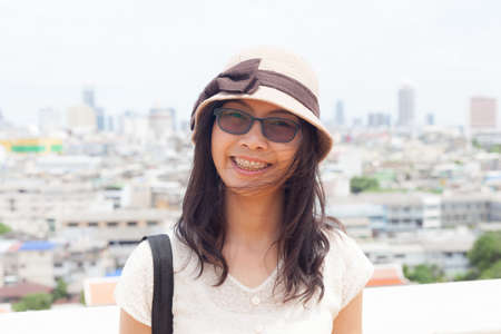 joy and smile asia woman.wear eyeglasses and hat.smile and relax.の写真素材
