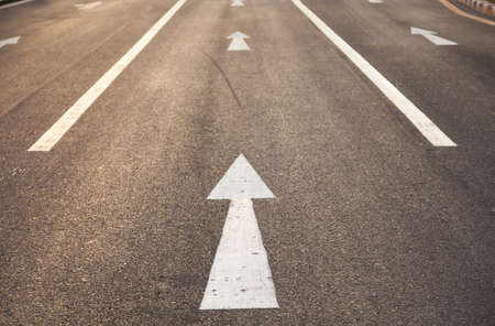 White arrow straight. Is on the road to a straight forward direction.の写真素材