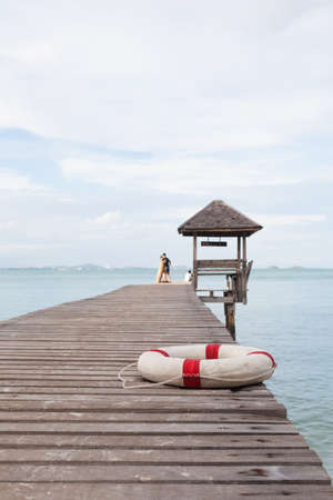 Rubber loop on a wooden bridge Behind the wooden pavilion in the sea. Mostly clear skiesの写真素材