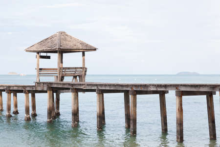 Wooden bridge and pavilion In the sea near the shore of the beach sand.の写真素材