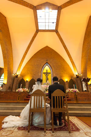 groom and bride in a wedding ceremony. The ceremony, which was held in the church of Christianity.のeditorial素材