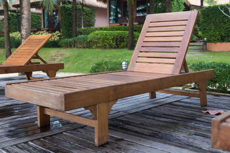 Wooden bed on the balcony. Beds made of wood under a tree on the terrace.の写真素材