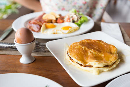 Pancakes and poached eggs Breakfast Puck's eyes at Carmi placed on the table.の写真素材