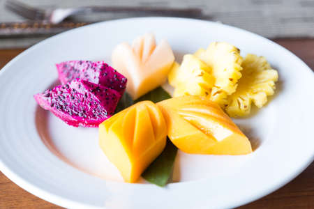 Fruit in white dish Placed on a table in the restaurant for breakfast.の写真素材