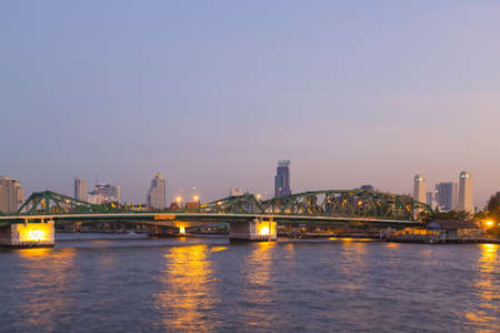 River Bridge in Bangkok city during the evening with the lights of buildings and lamp.の写真素材