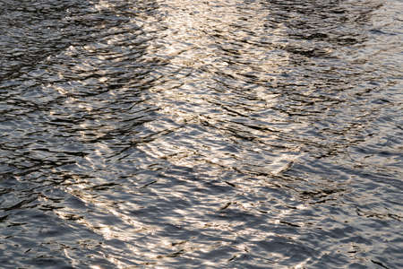 Sunlight reflected on the water. In the evening sun, the sun's reflection on water.の写真素材