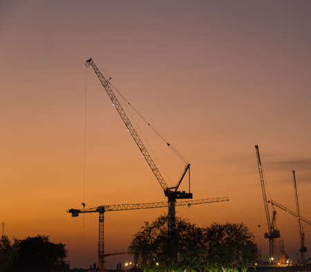 Construction cranes in evening Construction cranes are building in the evening.の写真素材