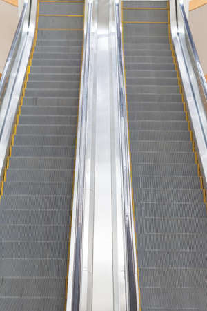 Escalator in a mall The up and down in a high-rise building within the department.
