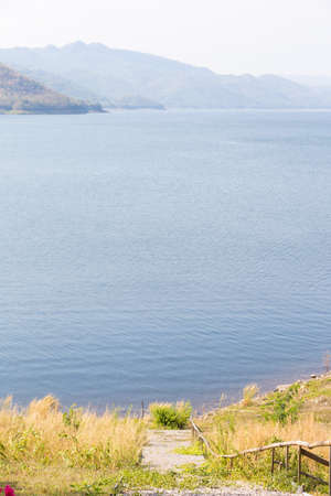 Stairs to the river The mountain in front The grass on either side.の写真素材