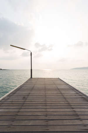 Bridge walkway at sea. A small harbor in the atmosphere at the morning sun.の写真素材