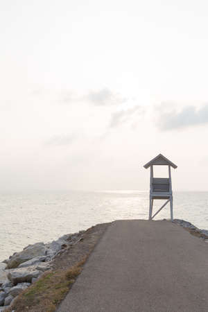 Wooden lighthouse on the seafront. The end of the boardwalk.の写真素材