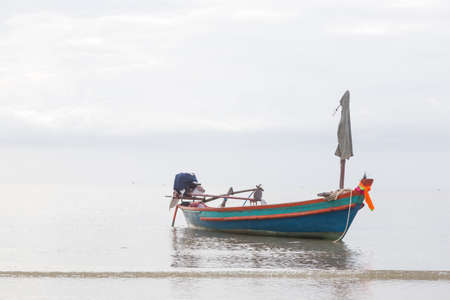 Small fishing boat. The park is on the beach during the evening.の写真素材