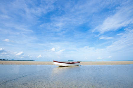 small boat on the beach. boat moored on the sand by the sea.の写真素材