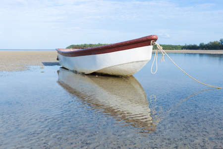 small boat on the beach. boat moored on the sand by the sea.の写真素材