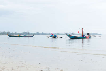 Many fishing boats Parking on the sea beach.の写真素材