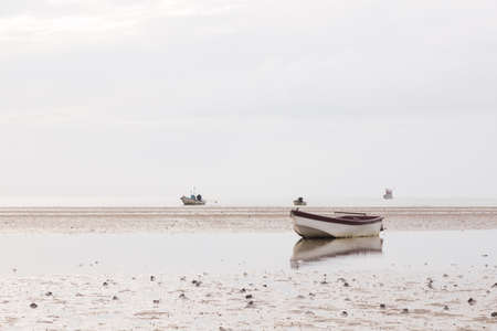 Small fishing boat. The park is on the beach during the evening.の写真素材