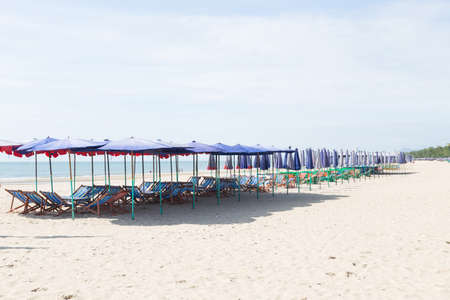 Beds and umbrellas on the beach. Seaside holiday in nature.の写真素材
