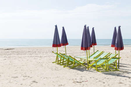 Beds and umbrellas on the beach. Seaside holiday in nature.の写真素材