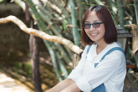 Asian woman wearing glasses smile happily on holidays.の写真素材