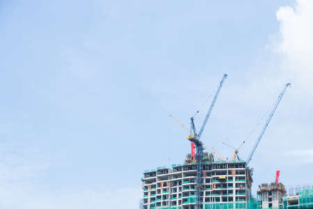 Tower crane are build skyscraper in city at day.の写真素材