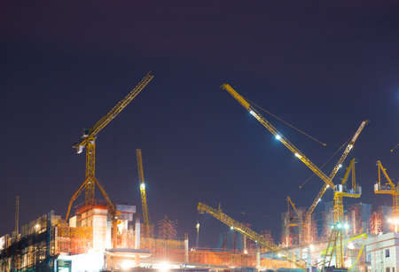 Heavy crane build new town in city when night fallのeditorial素材