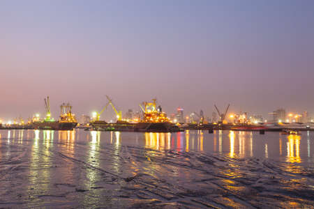 Refinery at night Light and oil tanker landing docksのeditorial素材