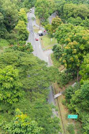 The road passes through the park in Singapore. Used in the traffic of garden space.のeditorial素材