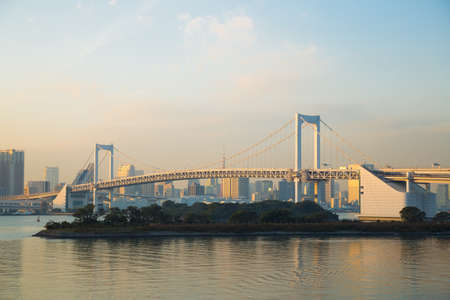 Rainbow bridge in evening at odaiba in Japan. Bulidng and skyscraper in City.の写真素材