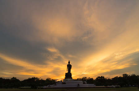 Silhouette large buddha in evening. Sunset background in evening at park public.の写真素材