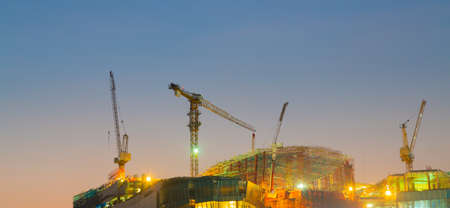 crane on the building, the construction of a high-rise building in the eveningの写真素材