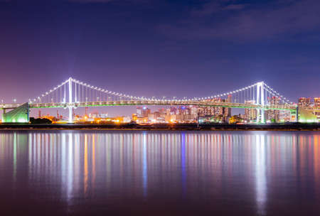 rainbow bridge in japan. In twilight time building and skyscraper background of bridge.の写真素材