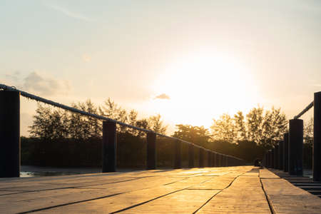Wooden bridge sea in sunset. Sunlight and sun in evening.の写真素材