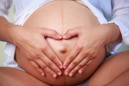 pregnant woman gently cradles her belly with love and anticipation.