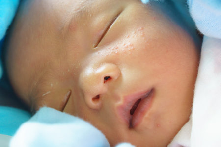 A peaceful sleeping baby with soft skin and delicate features, wrapped in light blue blanket. serene expression evokes warmth and tendernessの写真素材