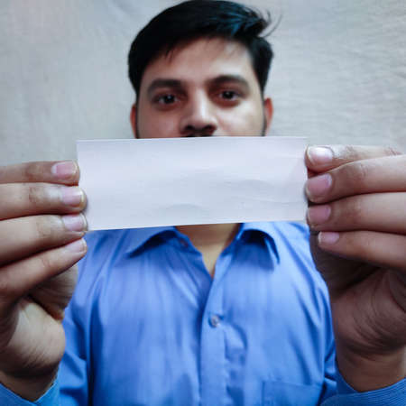 Empty poster or sticker in man hands, showing in camera, selective focus,の写真素材