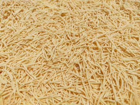 Uncooked Vermicelli pasta background made using refined floor wheat.の写真素材