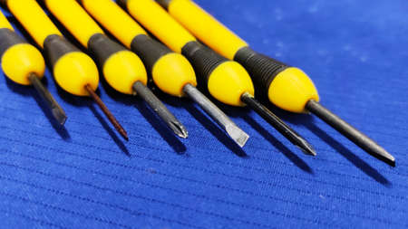 Small Screw Driver mini precision set on blue textured background.の写真素材