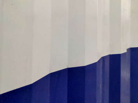 Blue White Textured Abstract background of bend tin shed