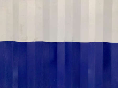 Blue White Textured Abstract background of bend tin shedの写真素材