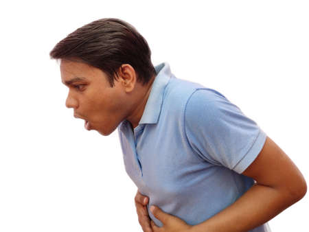young Indian man feeling sick and vomiting , he want to puke , isolated on white backgroundの写真素材