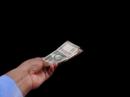 Indian Banknote in hand offering money Concept on back background