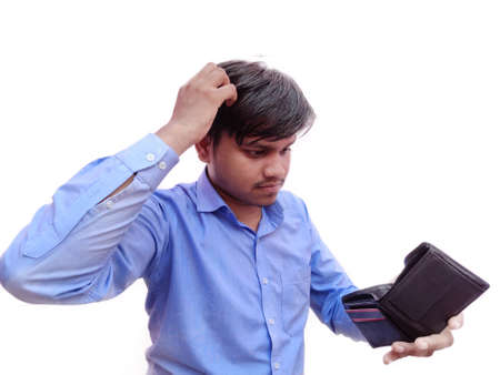 Indian man wearing a blue shirt stressed because empty wallet no money isolated on white background....