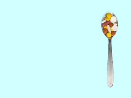 Pills in spoon kept on blue paper for Daily dose, copy space Selective focusの写真素材