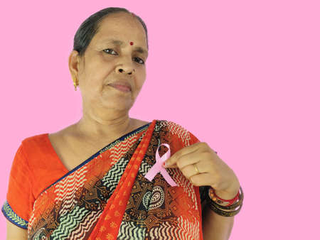 Woman pointing finger on Pink ribbon a symbol of fight against cancerの写真素材