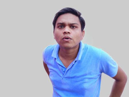 Uncertain young man facial expression asking question.の写真素材