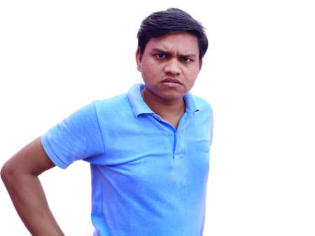 Very angry young man in t shirt staring vigorously , shouting
