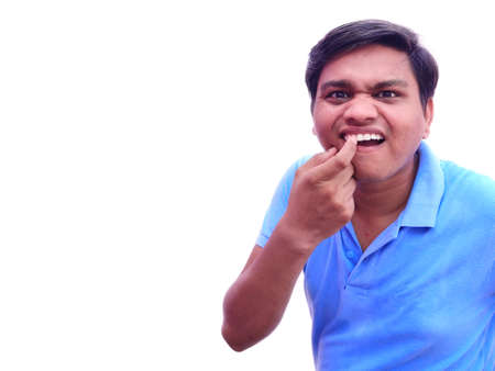 Man checking his teeth as having pain and inflammation in gumsの写真素材