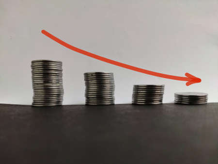 Coin stack step down graph with red arrow, Risk management business financial and investment, Copy spaceの写真素材