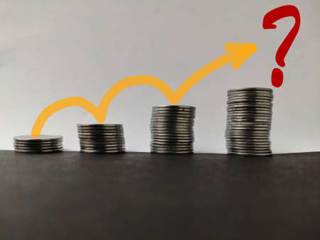 Increasing piles of coins with going up trend line with question mark , Concept for bullish market and economy growthの写真素材